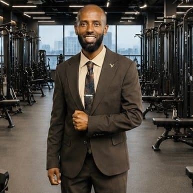 Awet, founder of Thrive Health & Fitness, standing in the gym