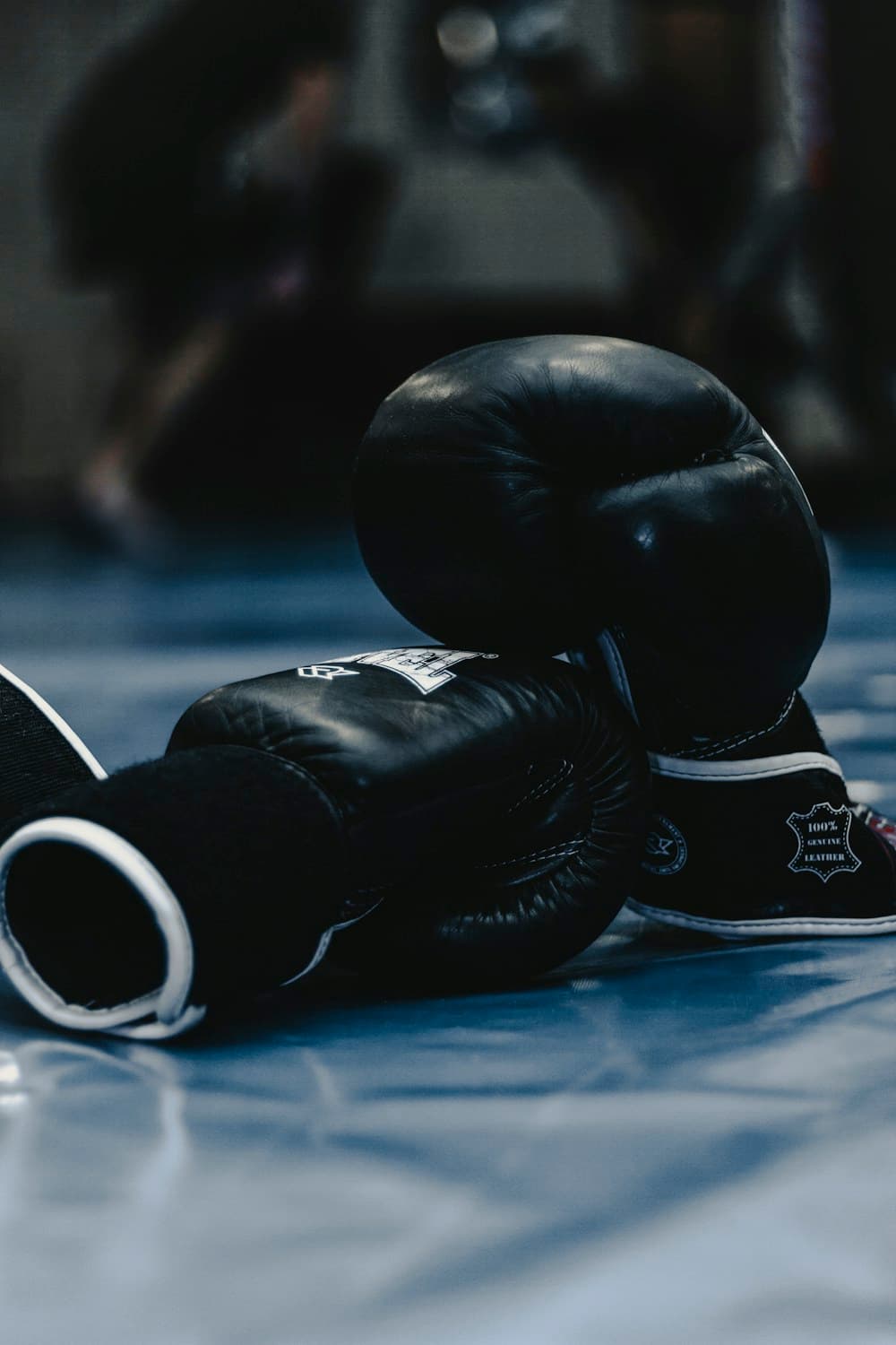 Boxing gloves resting on the floor of a martial arts gym