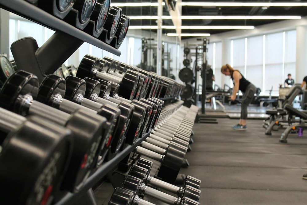 Dumbbells and equipment across a fully equipped strength training floor